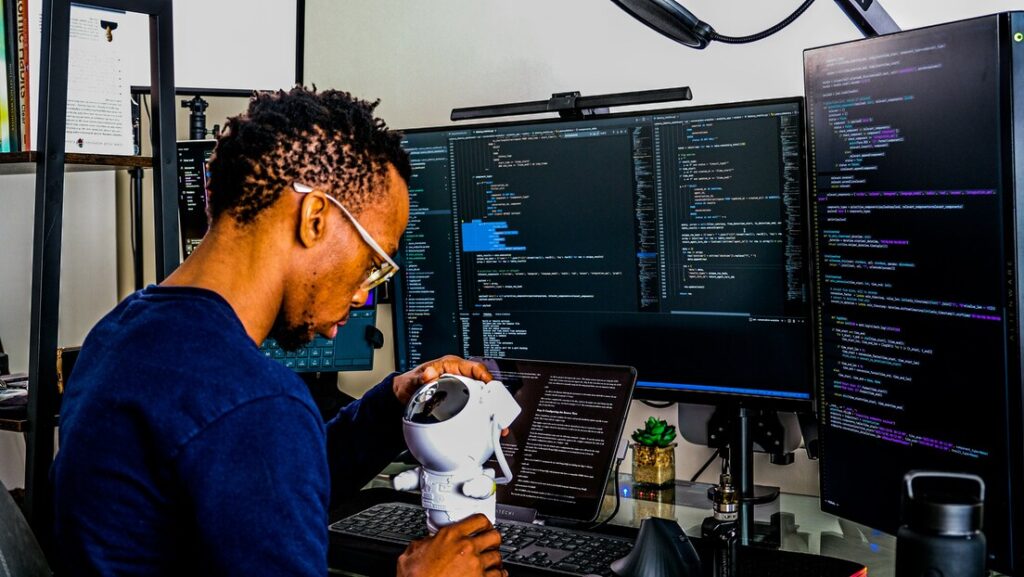 computer and a man with a robot